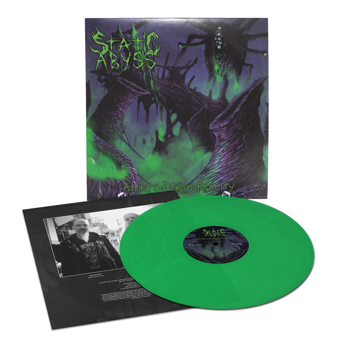 The Static Abyss toxic green vinyl record, titled "Aborted From Reality," is shown with dark surreal death metal cover art of monstrous tentacled creatures and includes an insert with black-and-white band photos and text.