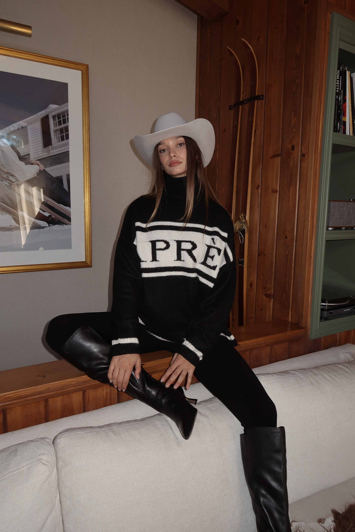 Alternate angle of the black sweater highlighting the overall design.