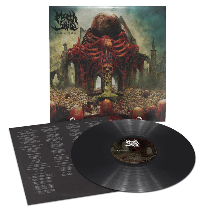 A US death metal vinyl album by MORTA SKULD with dark, surreal cover art showing a huge red skeletal structure amid ruins. The black vinyl and lyric sheet are displayed in front. The band logo reads MORTA SKULD.