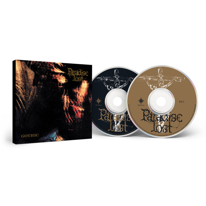 A Paradise Lost CD set of "Gothic" is displayed, featuring two discs—one black and one gold—with atmospheric death/doom tracks, plus the album cover with gothic artwork and the band's stylized name.