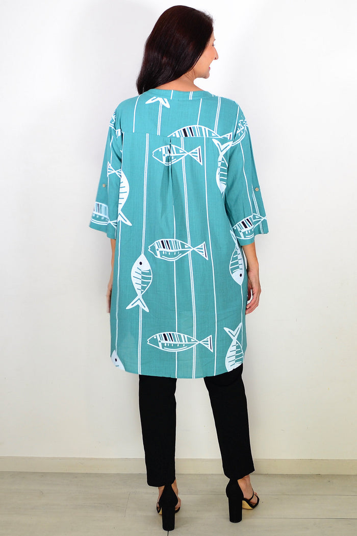 Green Ruby Rain hi-low relaxed tunic shirt with long sleeves and a flowing fit, displayed on a hanger.