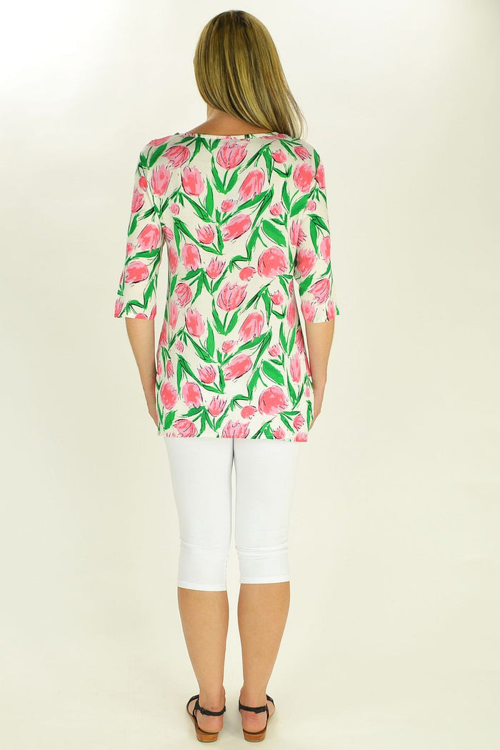 Sun Rose Pink Tulips Tunic displayed on a hanger, featuring a vibrant pink floral design and lightweight fabric.