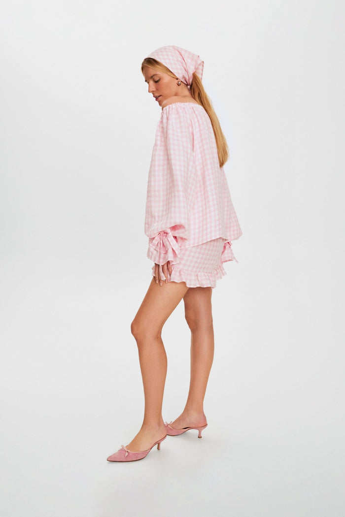 side-view-of-woman-wearing-long-sleeve-with-adjustable-ties-on-linen-lounge-blouse-with-matching-shorts-and-headscarf
