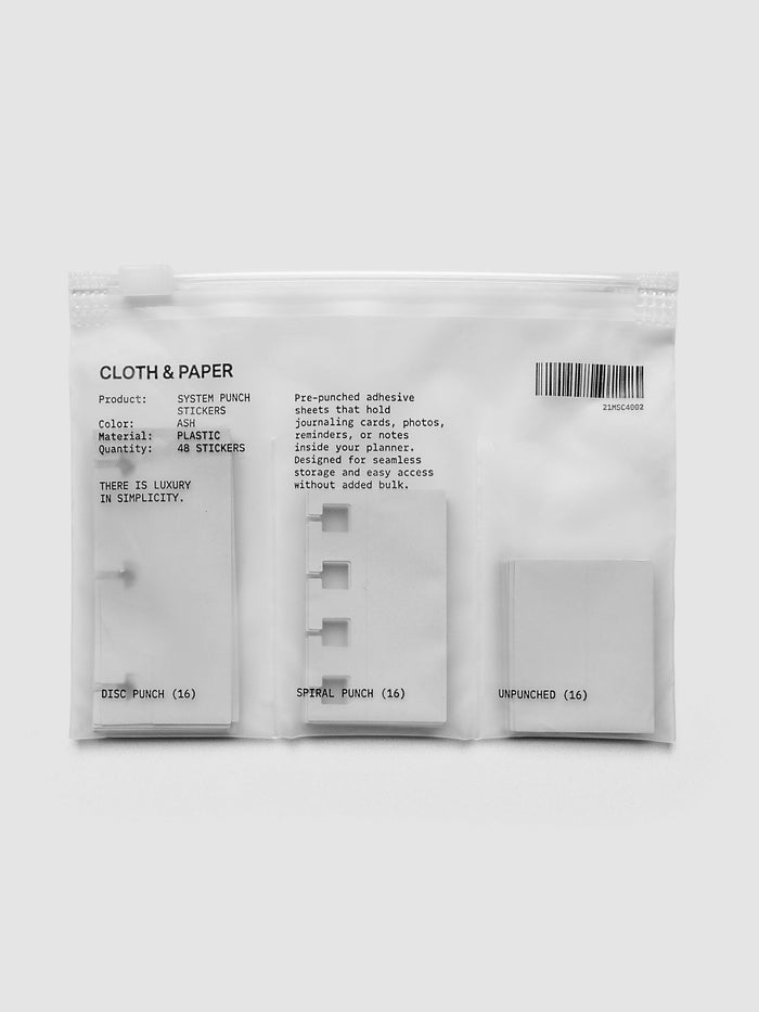 Clear zippered bag of system punch stickers including disc punch, spiral punch, and unpunched.