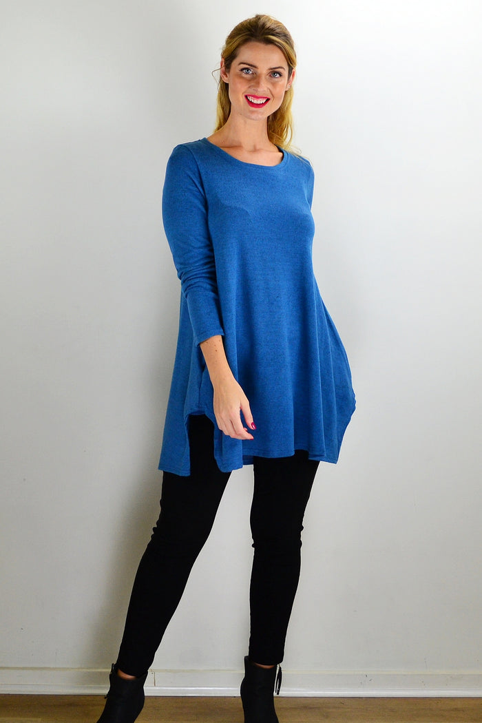 Teal blue knit tunic top by Hourglass, featuring a cozy, fitted design with long sleeves and a round neckline.