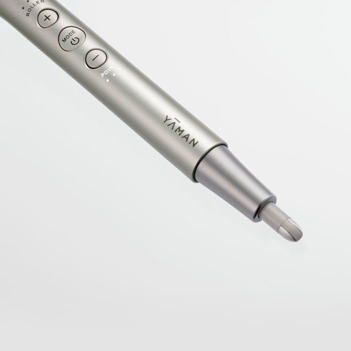 Silver electronic device with 'YAMAN' branding on a light gray background