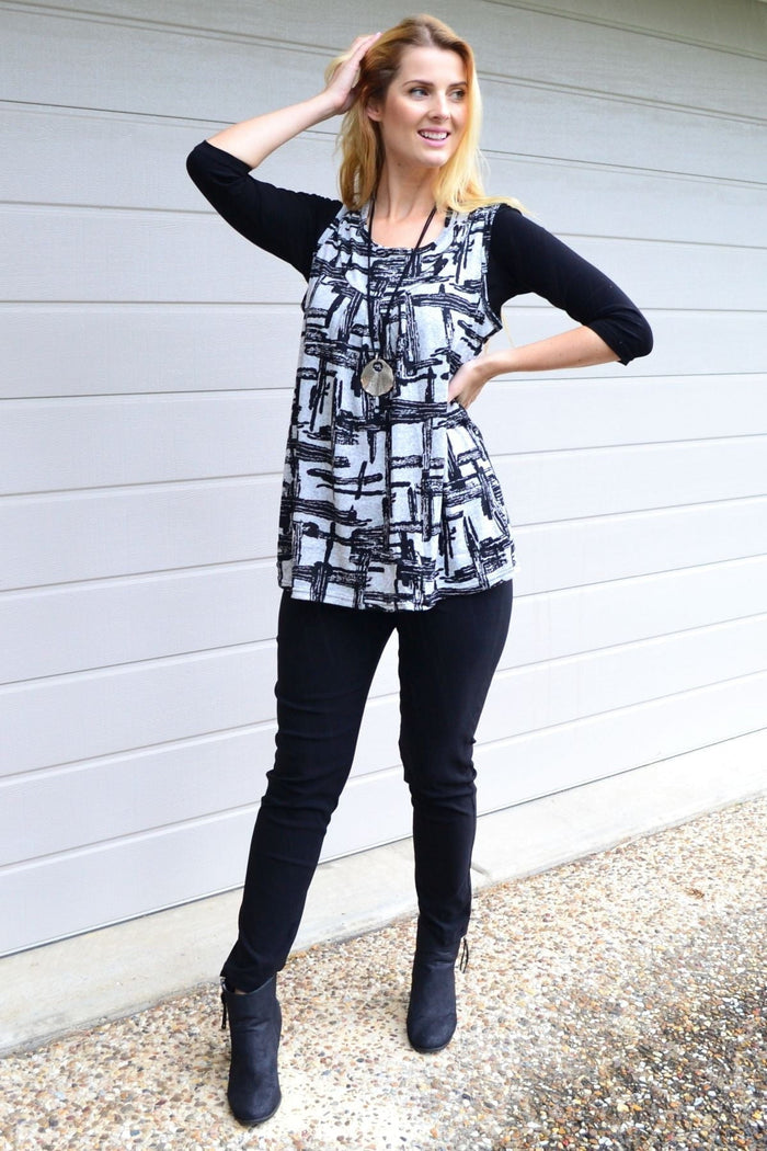 Abstract sleeveless fleece tunic top by Lilia Whispers displayed on a hanger with soft fabric texture and relaxed fit.