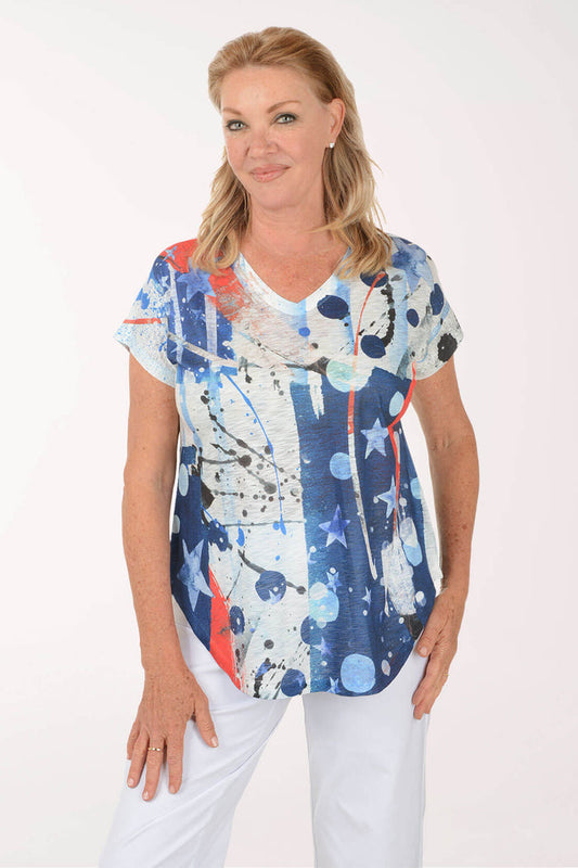 Woman wearing a colorful abstract patterned top on a white background