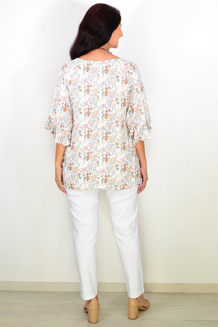 Wishstone Autumn Harvest Tunic Top with floral pattern, long sleeves, and relaxed fit displayed on a model.