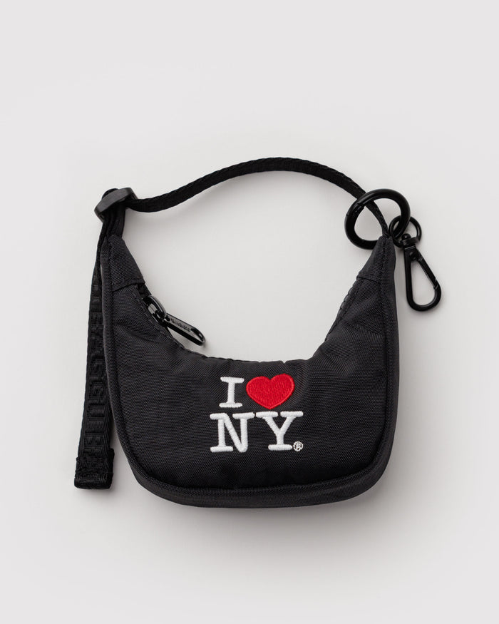 Black crescent bag charm with 'I ❤️ NY' text in red with adjustable strap and metal clip.