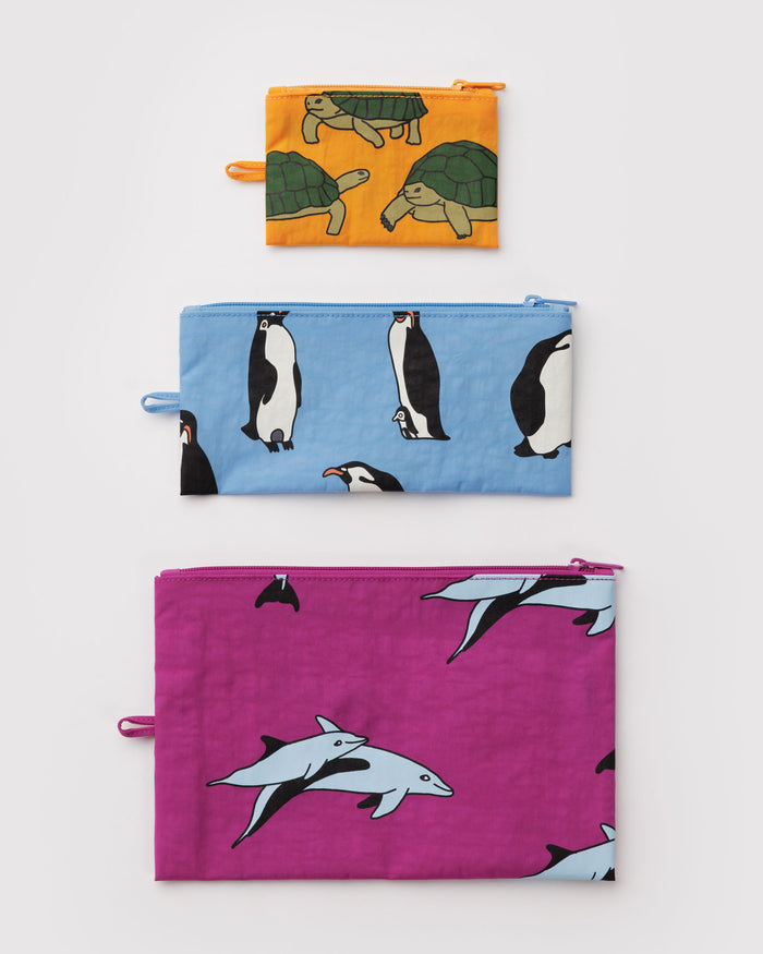 Three zip top fabric pouches with animal patterns in a small, medium and large size with a hanging loop at the side.