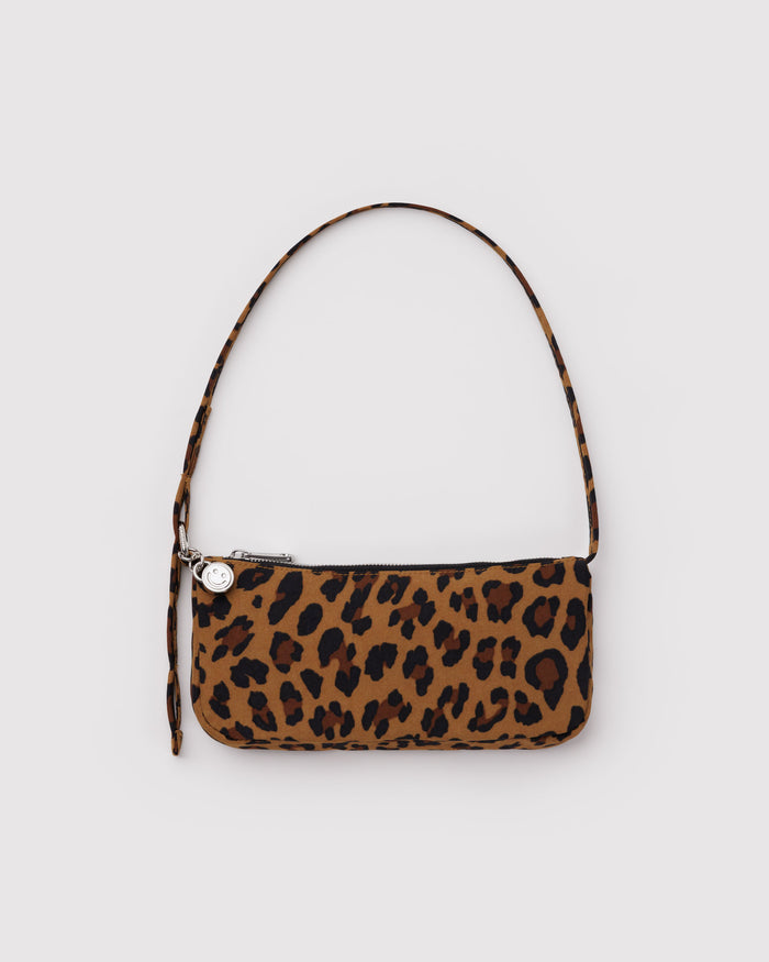 Leopard print handbag with a metal clasp to adjustable the shoulder strap and metal silver smiley face charm attached.