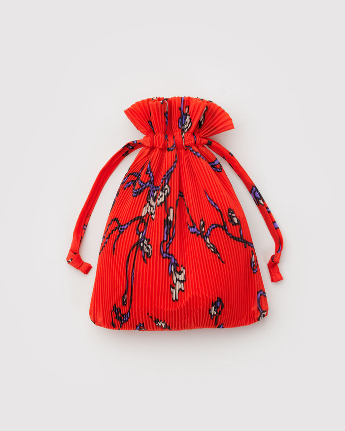 Red drawstring pleated bag with floral pattern.