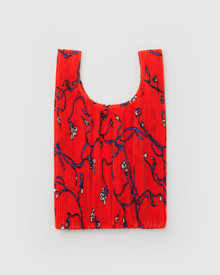 Red reusable shopping bag with blue floral pattern.