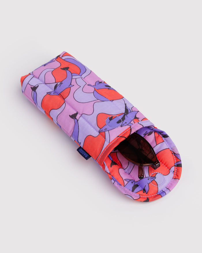 Colourful eyeglass case with abstract dolphin design and magnetic closure with sunglasses inside.