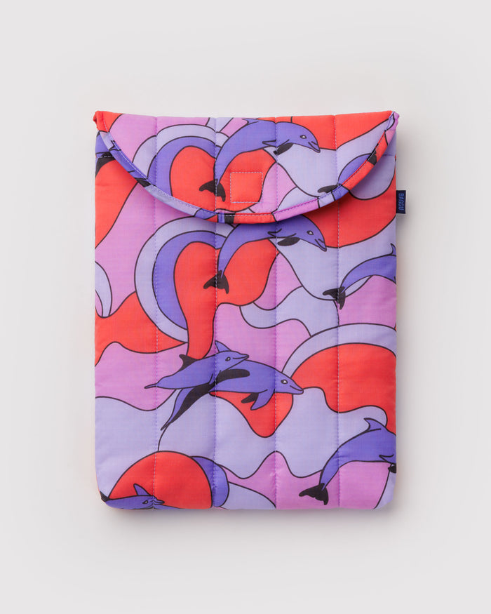 Puffy and quilted colourful laptop sleeve with purple dolphin pattern.