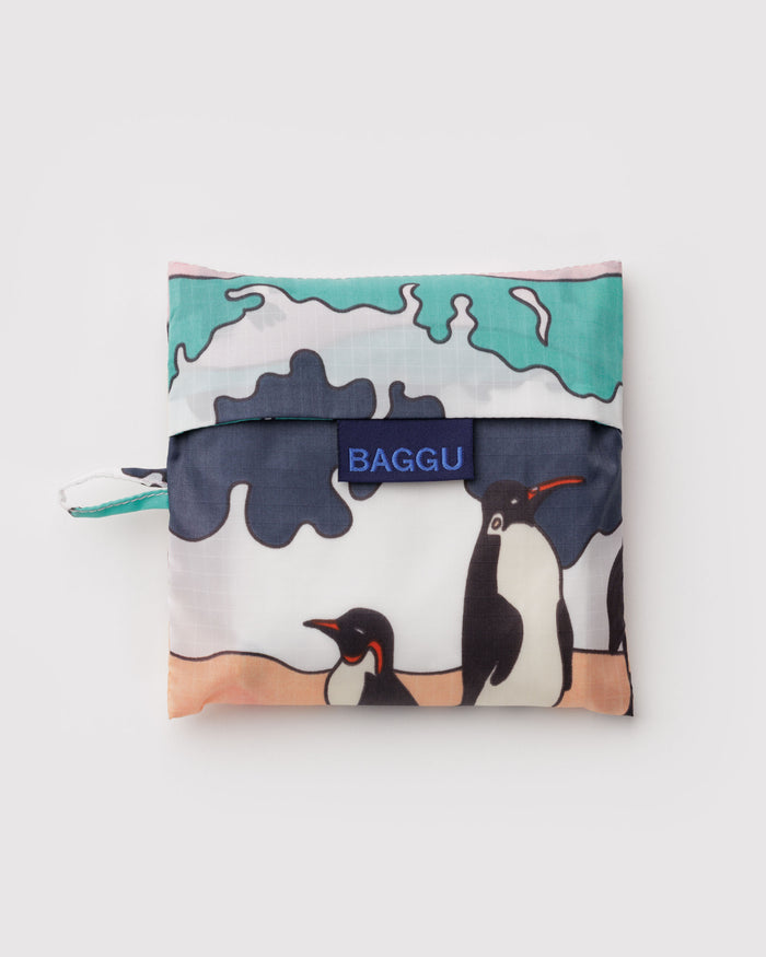 Foldable shopping bag with penguin design and 'Baggu' branding and hanging loop