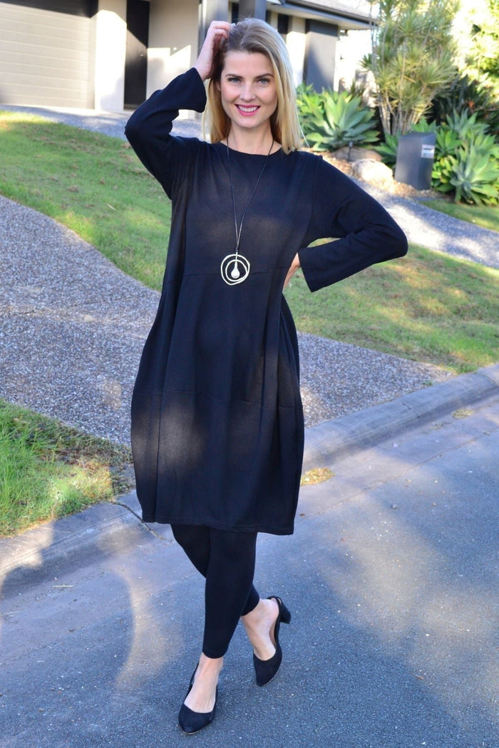 Black Cocoon Winter Pocket Tunic Dress by Peony, shown hanging with side pockets and a relaxed, cocoon silhouette.