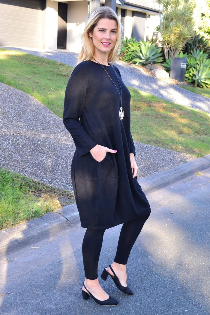 Black cocoon winter pocket tunic dress by Peony, featuring a relaxed fit with front pockets and long sleeves.