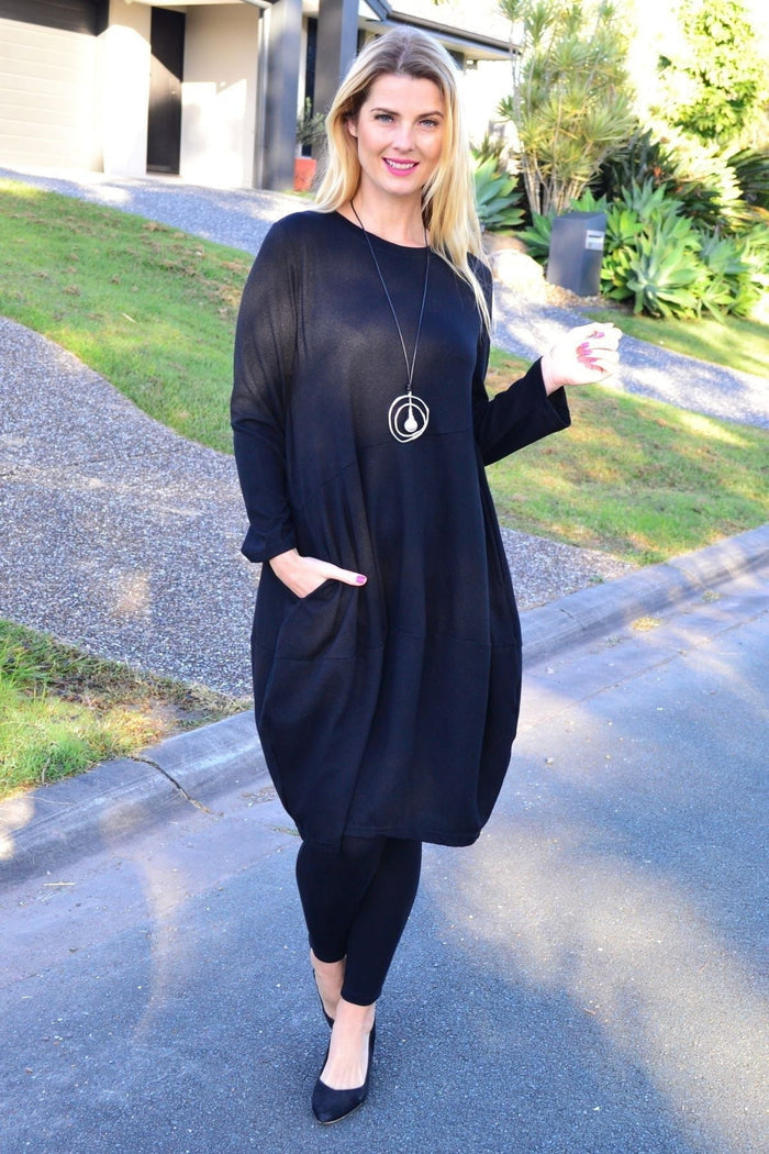Black cocoon winter pocket tunic dress by Peony, featuring a cozy silhouette with side pockets and a relaxed fit.