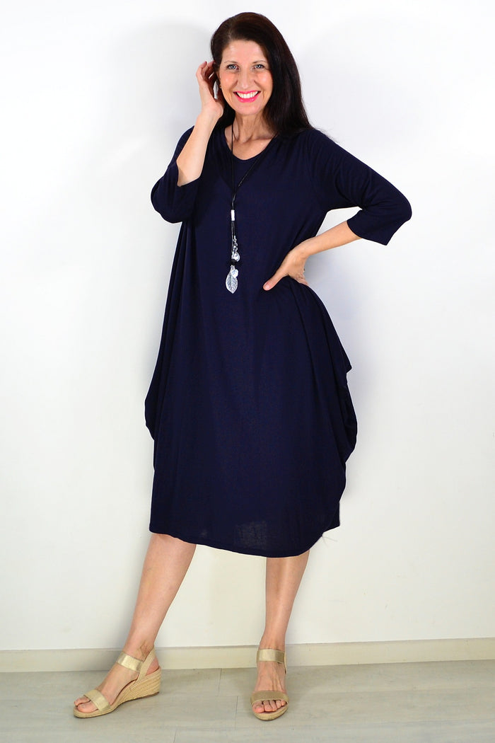 Black relaxed oversized tunic dress by Lilia Whispers, shown on a hanger with soft fabric draping and casual fit.