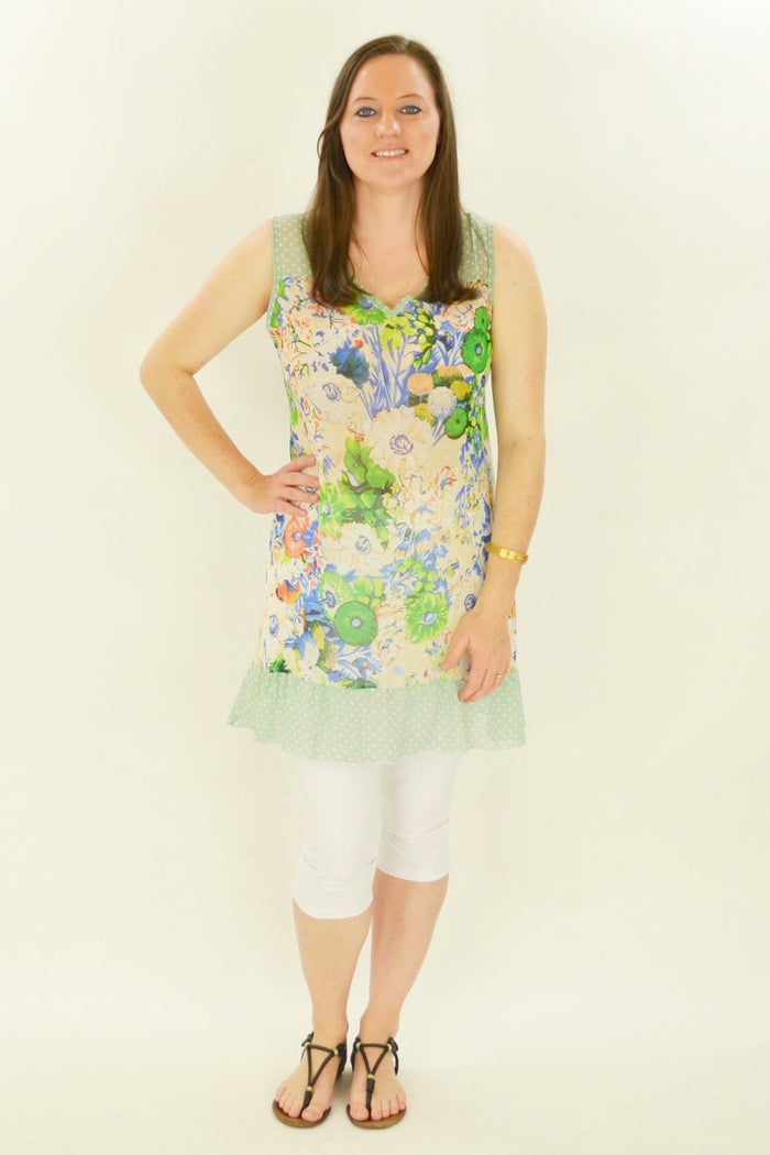 Blue Meadow Flowers Whispers tunic featuring a floral pattern and relaxed fit, shown on a hanger.
