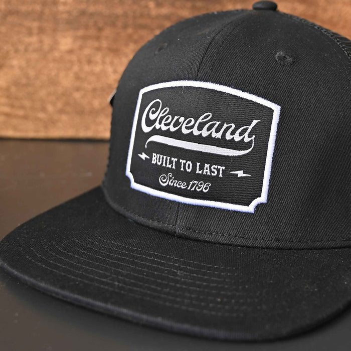 Cleveland built to Last black flat brim trucker hat front closeup detail.