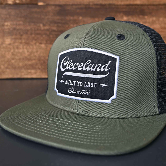 Cleveland Built to Last olive and black flat brim trucker hat front closeup detail..