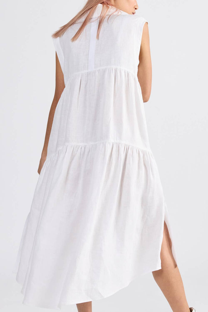 Back of a woman wearing an ivory sleeveless dress with side split - ANNIE.G