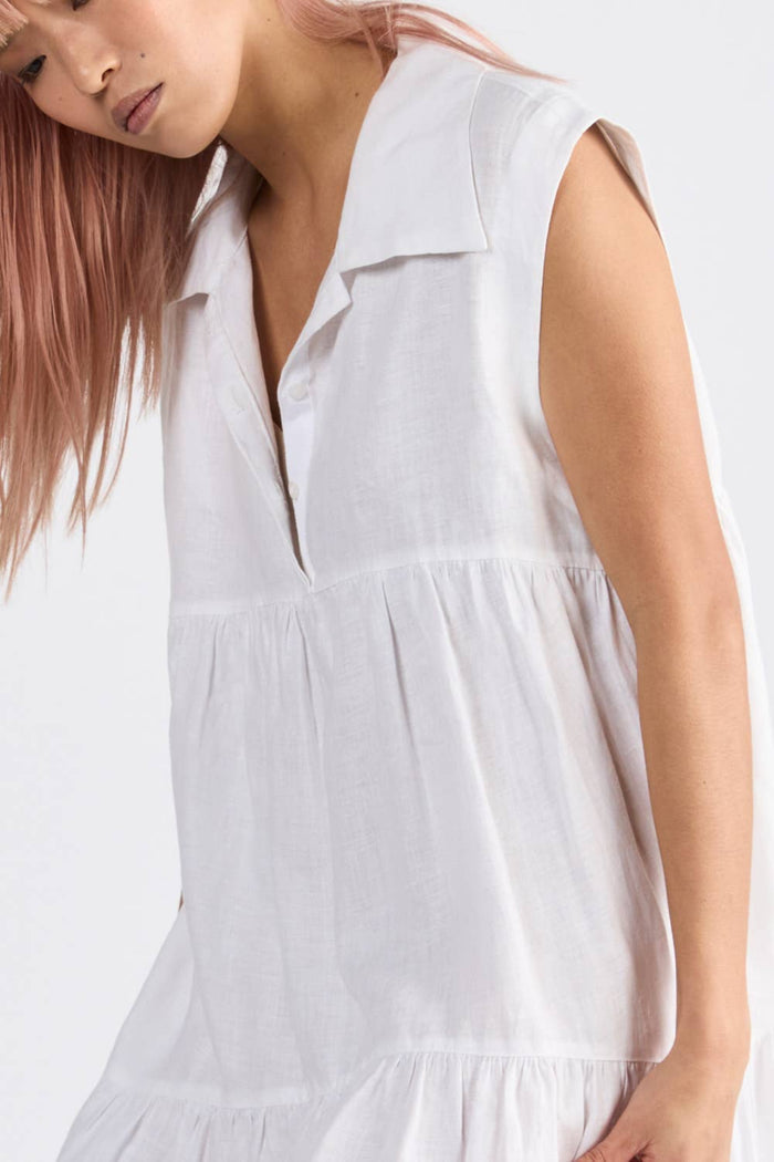 Woman wearing a sleeveless ivory dress with v neckline - ANNIE.G