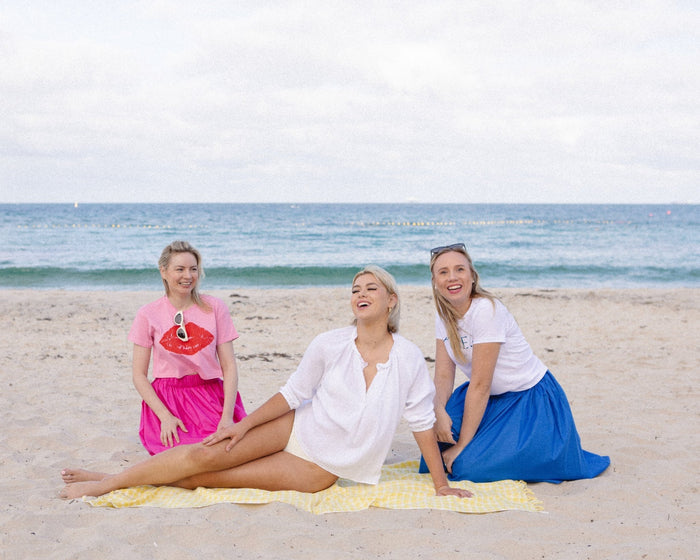 Women lying on the yellow check beach towel at beach - ANNIE.G