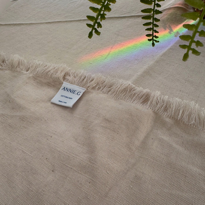 Blush tablecloth edge folded back showing label