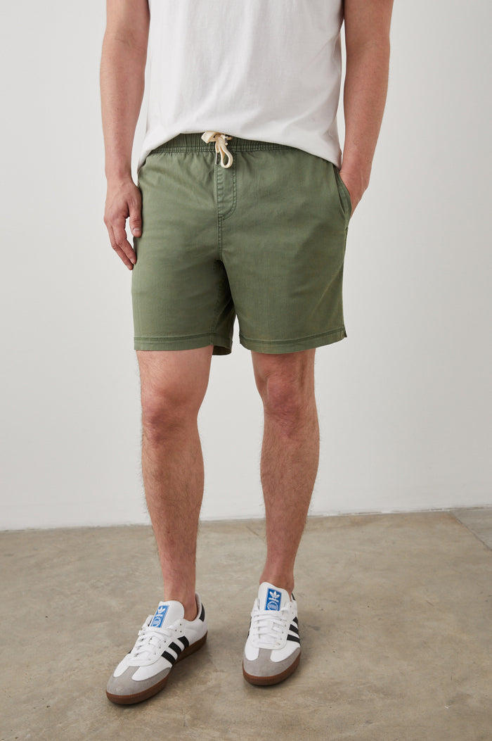 Cruz Short in Vintage-Washed Cotton With Drawstring Ties, Side Pockets, and Back Button Patch Pockets in Spring Olive Colorway - Lower Body Front View Featured on Model