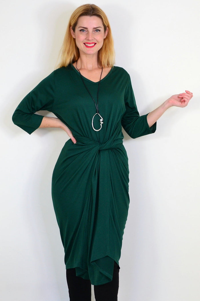 Dark green oversized tunic dress by Lilia Whispers, relaxed fit with long sleeves and a flowy silhouette, displayed on a hanger.