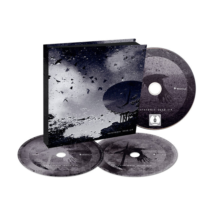 A limited edition Katatonia 2CD/DVD box set, Dead Air, featuring three discs with dark, atmospheric bird and satellite dish artwork and Katatonia Dead Air text on the case.