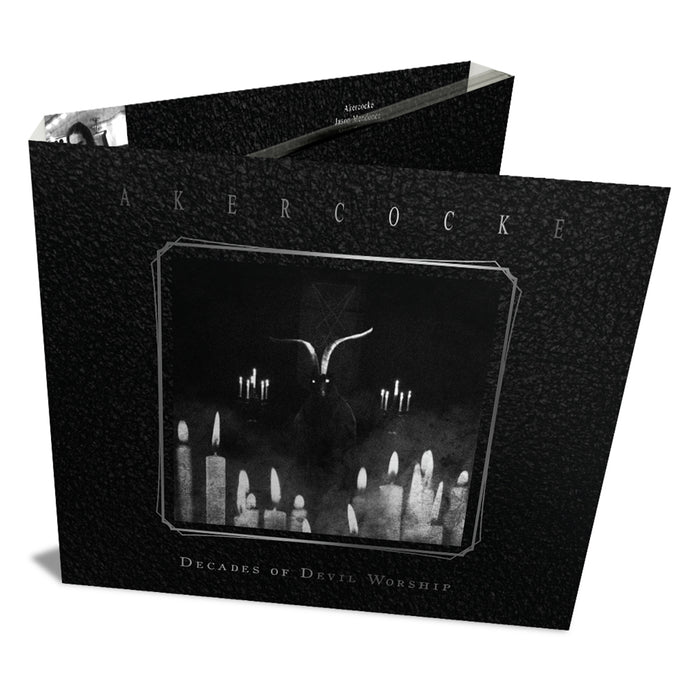A black CD case for Akercocke’s "Decades of Devil Worship" live album features a horned, goat-like figure amid lit candles on a textured black backdrop, with white text displaying the brand name Akercocke.