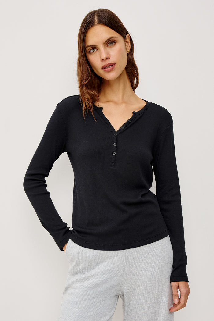 Essential Ribbed Henley With Front Placket and Long Sleeves in Black Colorway - Upper Body Front View Featured on Model