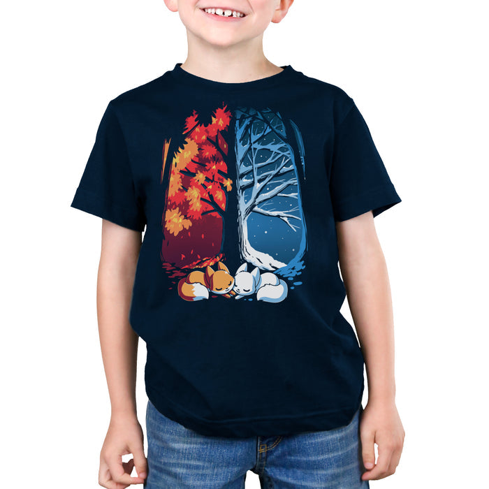 Premium Cotton T-shirt_TeeTurtle navy blue Fall & Winter Foxes apparel featuring an orange fox on the lefthand side, and a white fox on the righthand side with their cheeks touching in the middle, and a fall forest background on the left, and a winter forest background on the right.
