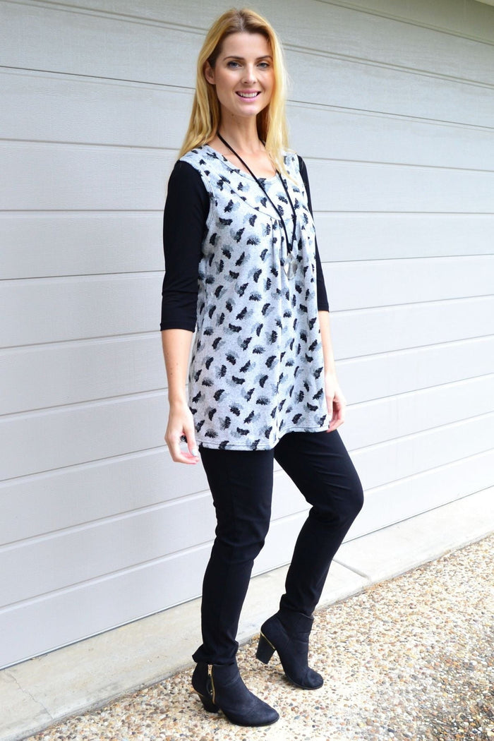 Lilia Whispers fern leaf sleeveless fleece tunic top displayed on a hanger, showcasing its cozy, leaf-patterned fabric and sleeveless design.