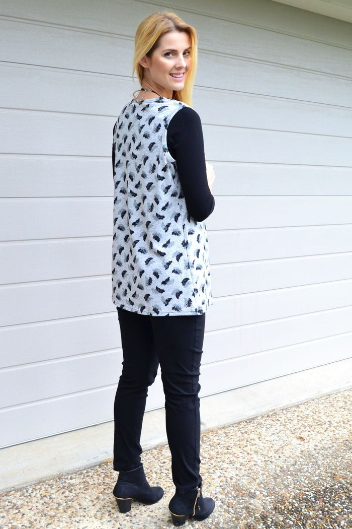 Lilia Whispers Fern Leaf Sleeveless Fleece Tunic Top with a fern leaf pattern, showcased on a hanger against a neutral background.
