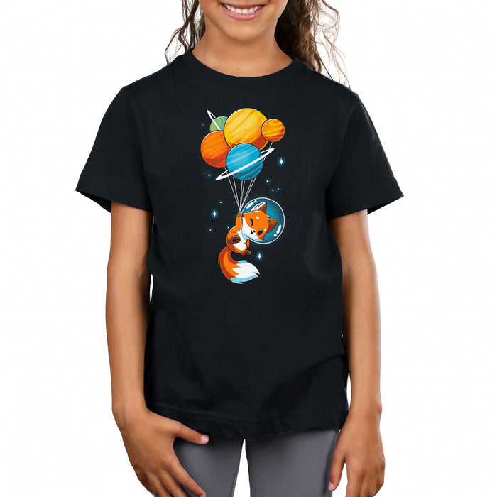 Premium Cotton T-shirt_TeeTurtle black Foxy Astronaut featuring a  cartoon fox in a space helmet is being lifted by balloons shaped like planets against a dark background.