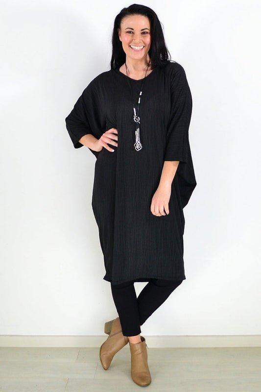 Black ribbed oversized tunic dress by Lilia Whispers, free size, featuring a relaxed fit and long sleeves.