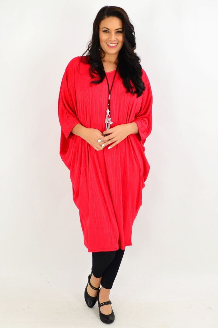 Red ribbed oversized tunic dress by Lilia Whispers, loose fit, long sleeves, and casual style, displayed on a mannequin.