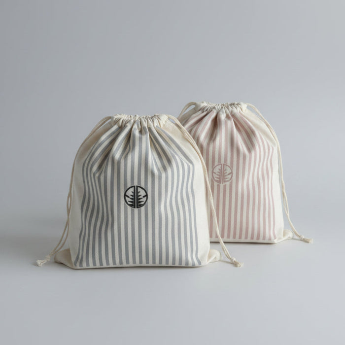 Two striped gift bags with 'AG' logo in pink stripes and blue stripes.