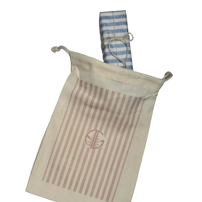 Cream gift bag with wrapped gift going inside.