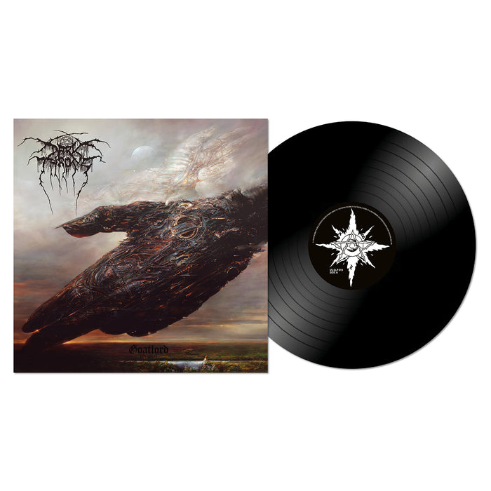 A black vinyl record by Darkthrone lies next to its cover, which shows dark, surreal art of a large ominous figure over clouds. The album title "Goatlord" and a spiky black logo evoke classic Norwegian black metal style.