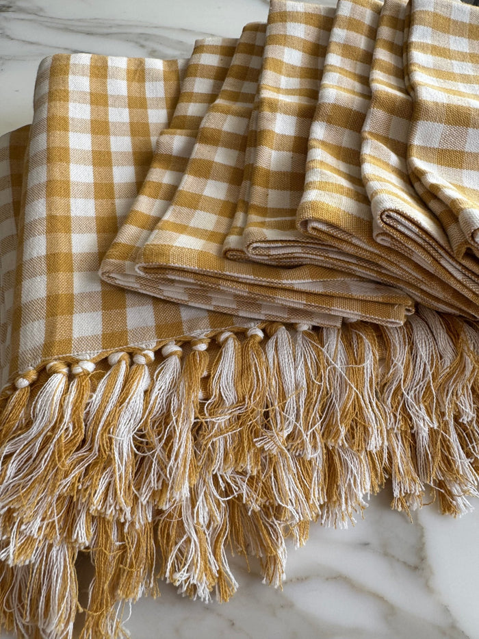 Stack of Gold and white checked Gingham Cotton Napkin Set of 4 and tablecloth on bench - ANNIE.G