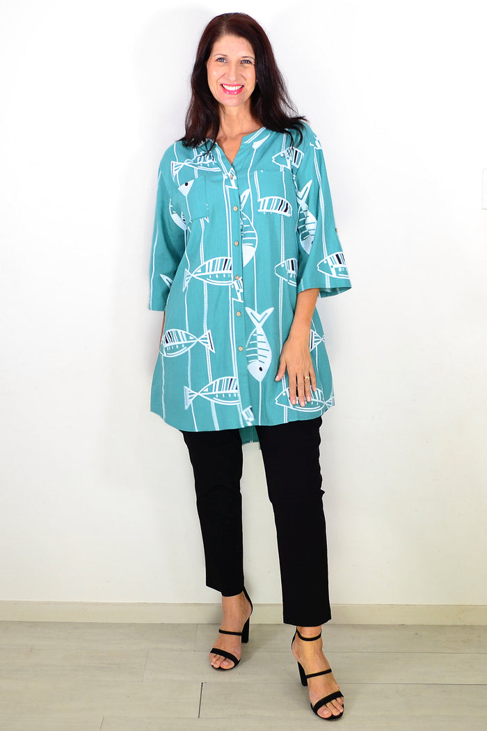 Green hi-low relaxed tunic shirt by Ruby Rain with a flowing fit and casual style, shown on a mannequin.