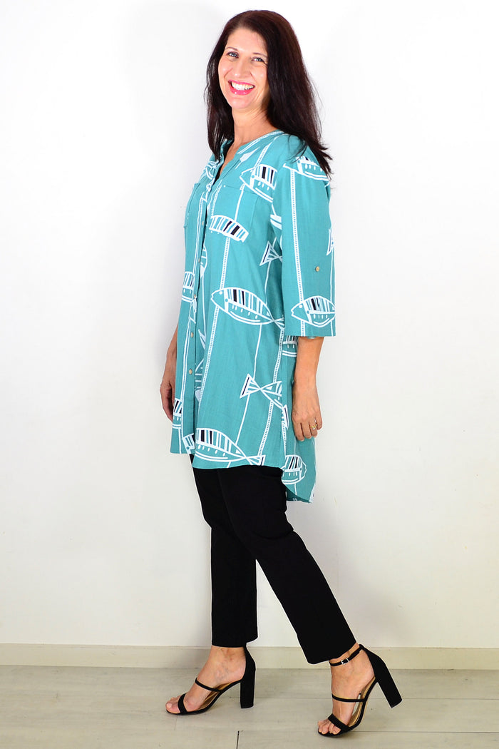 Green hi-low relaxed tunic shirt by Ruby Rain, featuring a flowy silhouette and casual fit, shown on a model.