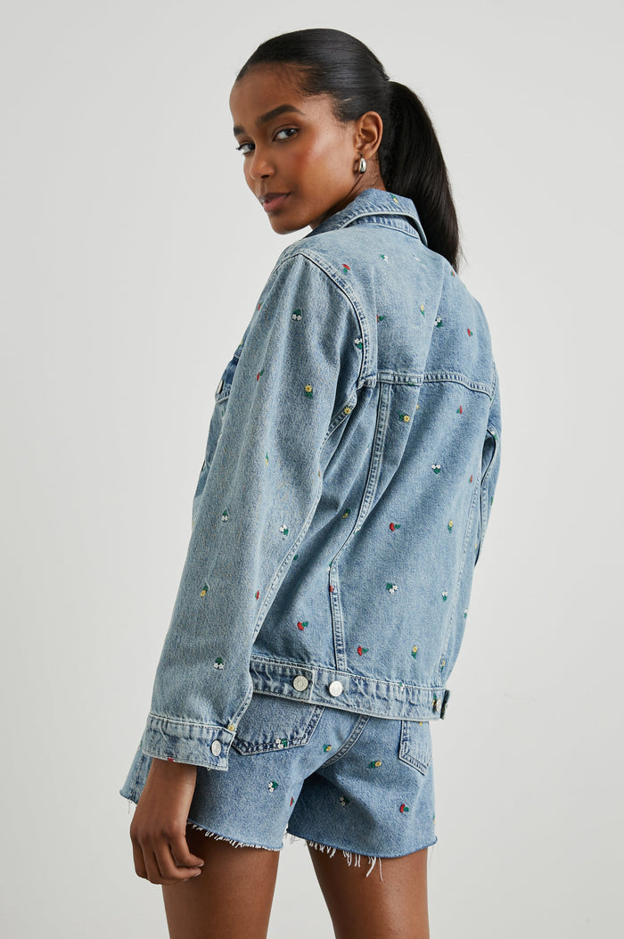 Grove Boyfriend Trucker Denim Jacket with Button Closure, Two Front Pockets, Two Chest Button Flap Pockets, Front Vertical Seams in Flower Field Colorway, with Embroidered Daisies in Yellow, Red and White - Back View Featured on Model